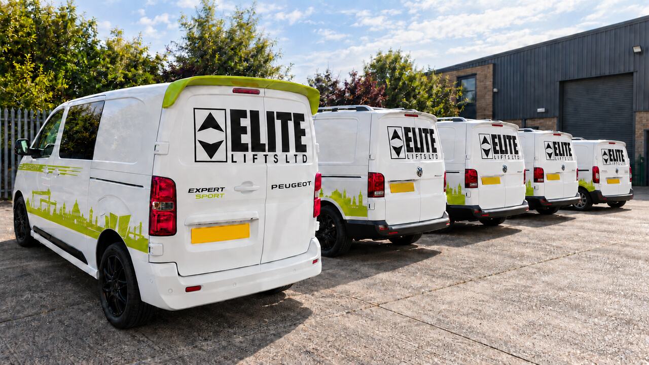Four branded Elite Lifts service vans lined up outside a commercial unit